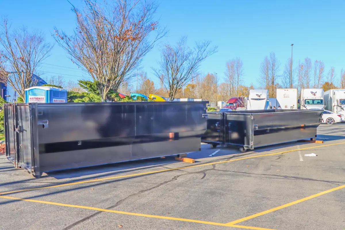 Professional dumpster rental service with roll-off container on residential driveway in Wantage